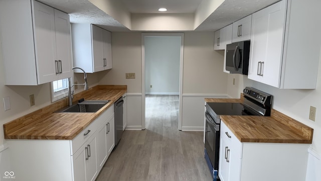 kitchen featuring white cabinetry and stainless steel appliances