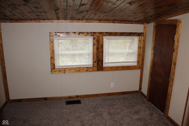 unfurnished room featuring carpet floors and wooden ceiling