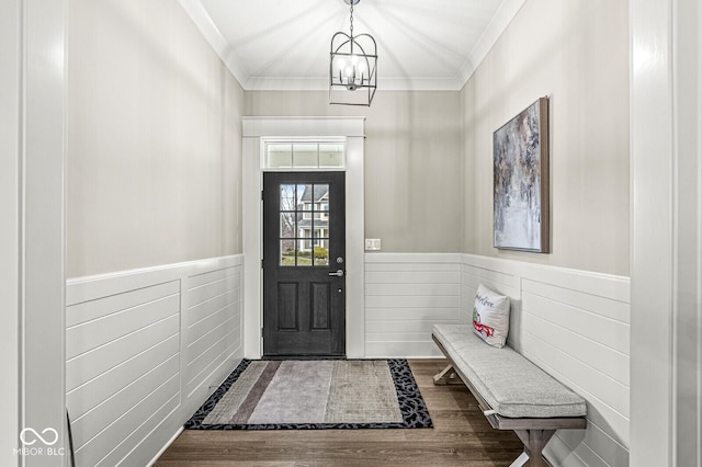 foyer with ornamental molding, a chandelier, and hardwood / wood-style floors