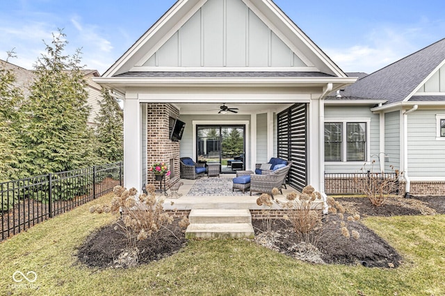 rear view of house with ceiling fan, a yard, outdoor lounge area, and a patio area