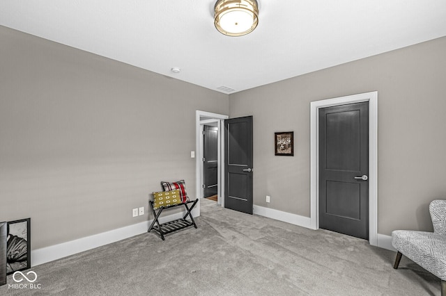 sitting room featuring light colored carpet