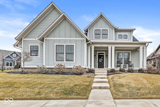 view of front of home with covered porch and a front lawn