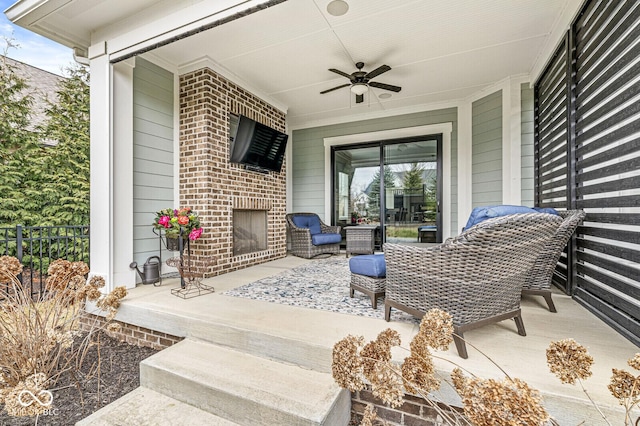 view of patio featuring an outdoor brick fireplace and ceiling fan