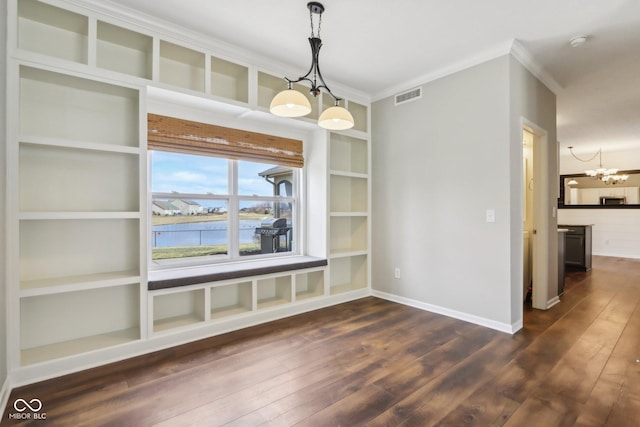 unfurnished dining area with dark wood-type flooring, a notable chandelier, visible vents, and built in shelves