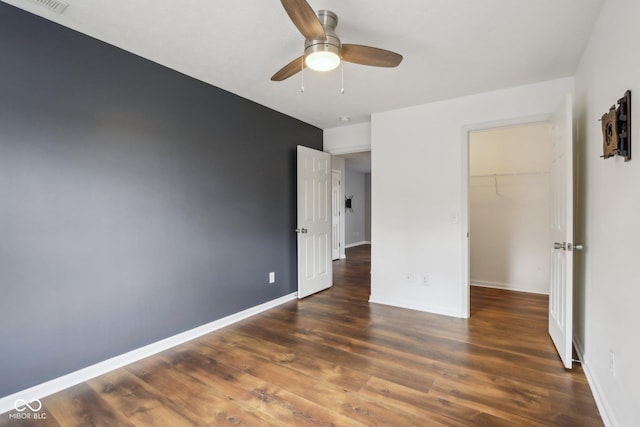 unfurnished bedroom featuring visible vents, ceiling fan, baseboards, and wood finished floors