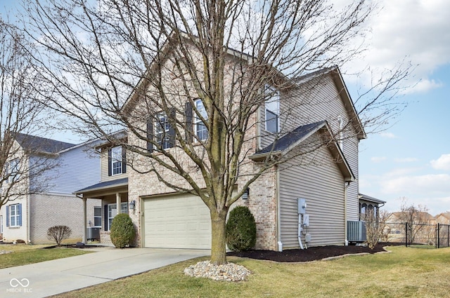 traditional-style house featuring a front yard, central AC unit, fence, driveway, and brick siding