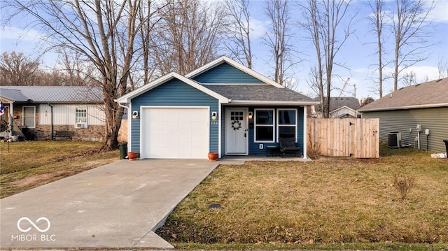 view of front of house featuring a garage, central AC unit, and a front lawn