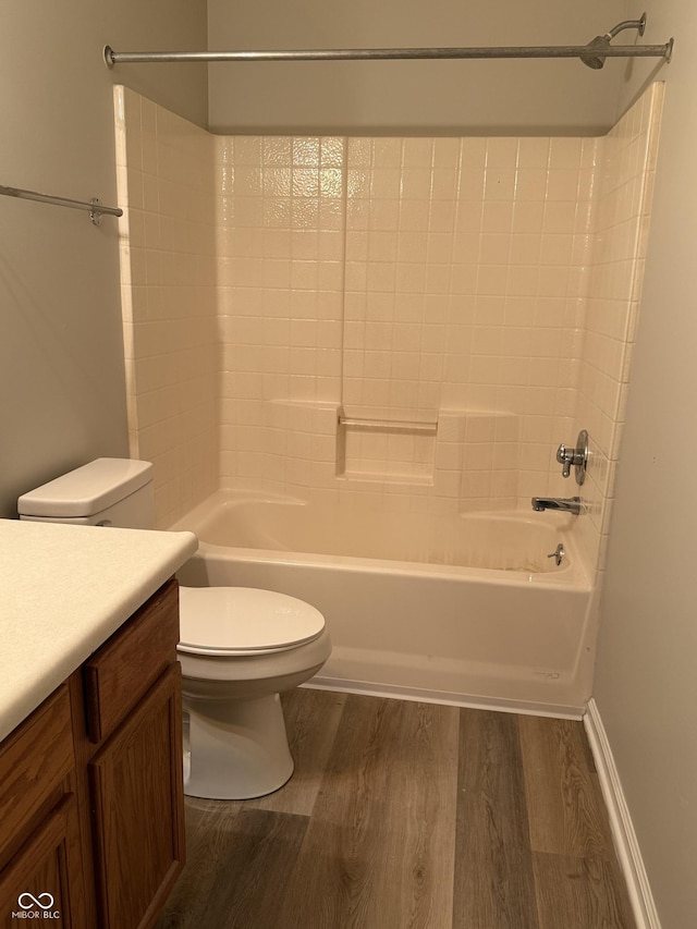 full bathroom with hardwood / wood-style flooring, vanity, shower / bathtub combination, and toilet