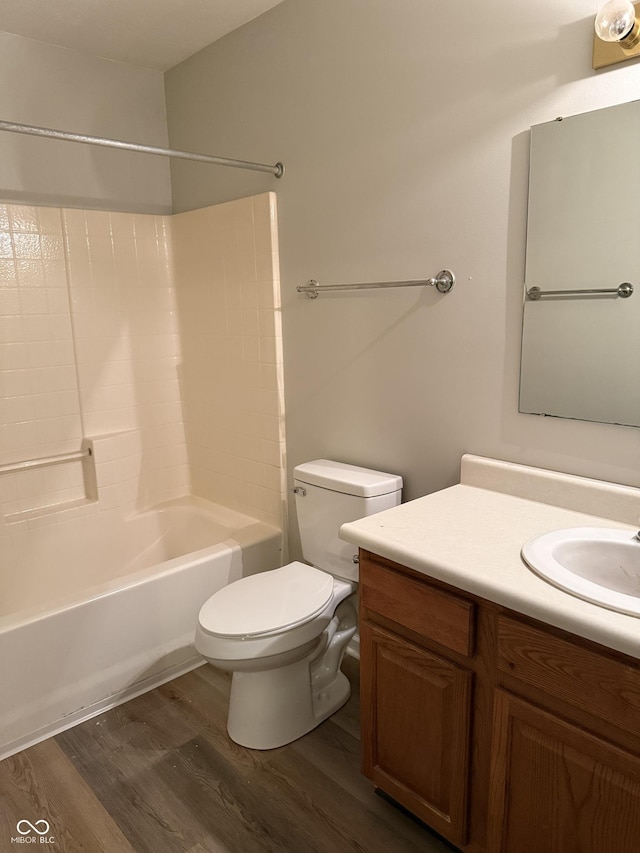 full bathroom featuring hardwood / wood-style flooring, vanity, toilet, and bathtub / shower combination