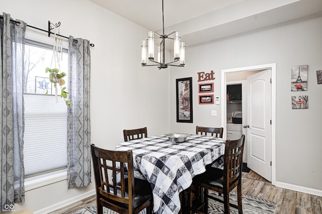 dining area featuring a notable chandelier and hardwood / wood-style flooring