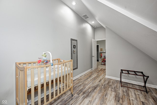 interior space with hardwood / wood-style floors and vaulted ceiling
