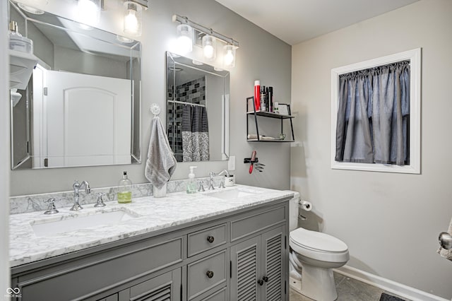 bathroom with vanity, toilet, and tile patterned flooring