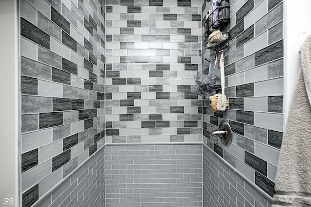 bathroom with tiled shower