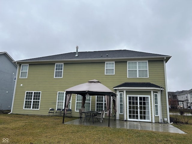 rear view of property with a gazebo, a yard, and a patio