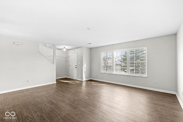 unfurnished living room with dark wood-type flooring