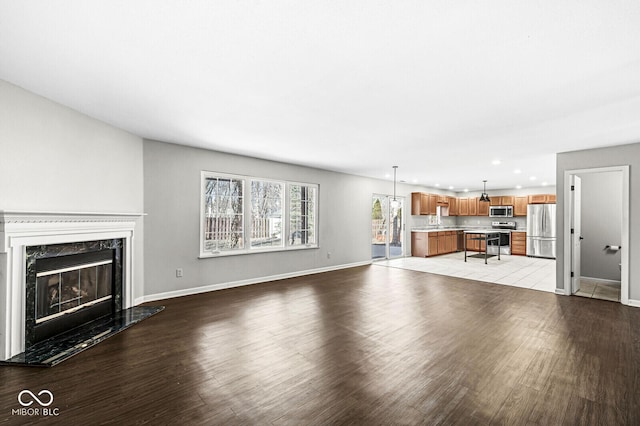 unfurnished living room featuring light hardwood / wood-style flooring and a fireplace