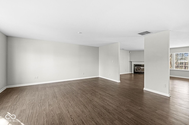 unfurnished living room with dark hardwood / wood-style flooring