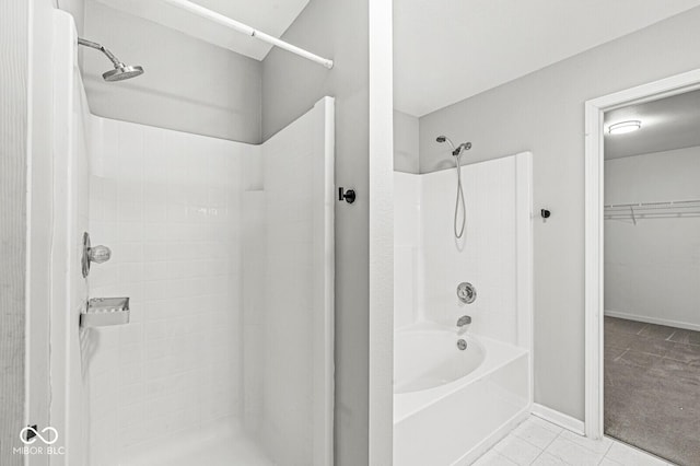 bathroom featuring tile patterned flooring and  shower combination