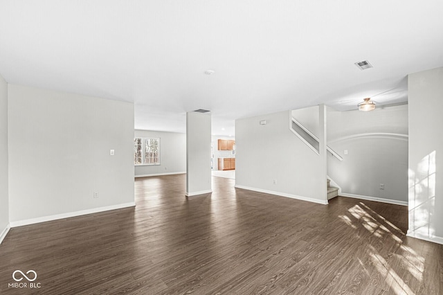 unfurnished living room with dark hardwood / wood-style floors