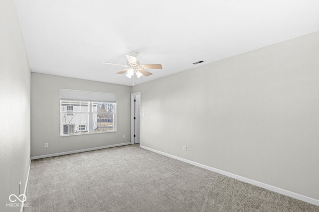 carpeted spare room with ceiling fan