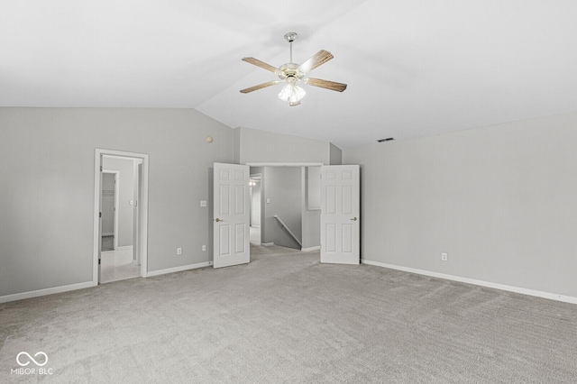 unfurnished bedroom with lofted ceiling, light carpet, and ceiling fan