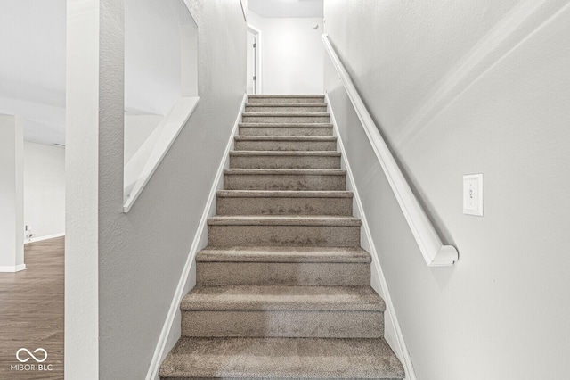 stairway featuring hardwood / wood-style flooring