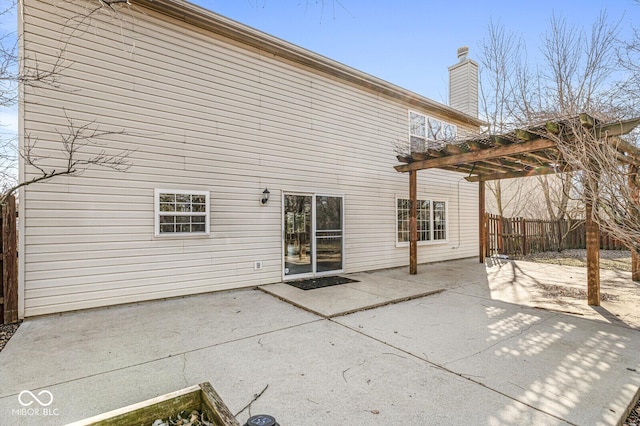 rear view of house featuring a patio and a pergola