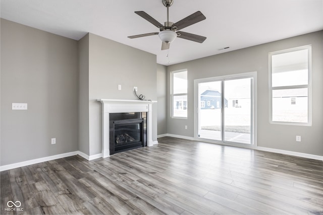 unfurnished living room featuring hardwood / wood-style flooring and ceiling fan