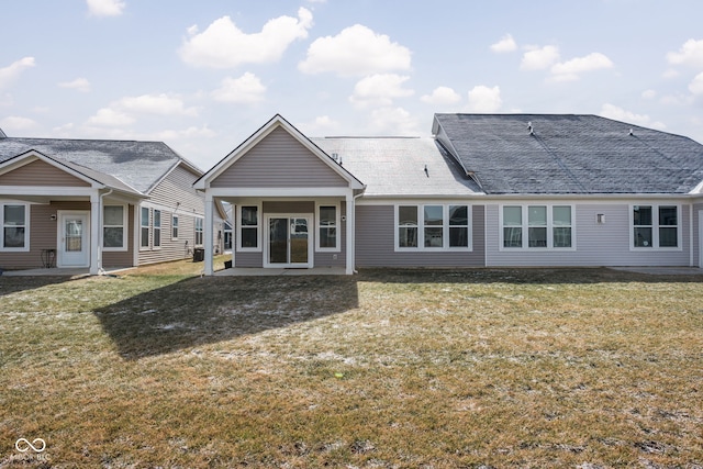 back of property featuring a lawn and a patio