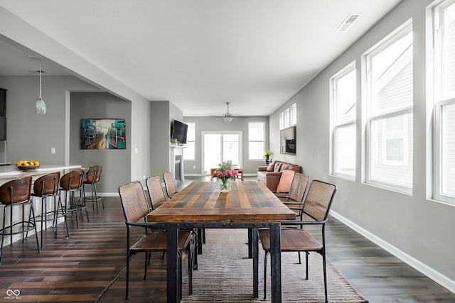 dining area with dark hardwood / wood-style floors and ceiling fan