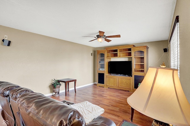 living room featuring light hardwood / wood-style flooring and ceiling fan