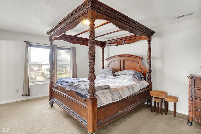 bedroom with light carpet and a textured ceiling