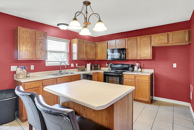 kitchen with sink, a kitchen bar, hanging light fixtures, light tile patterned floors, and black appliances