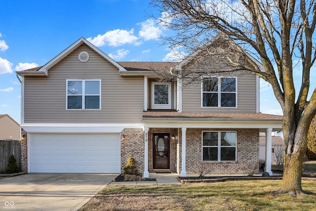 front of property featuring a garage, a porch, and a front yard