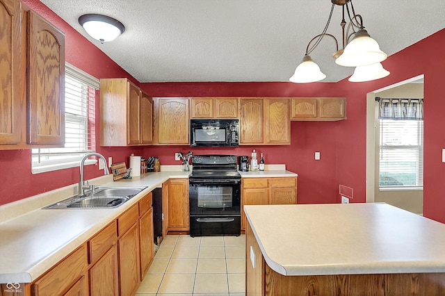 kitchen with sink, light tile patterned floors, a center island, black appliances, and decorative light fixtures