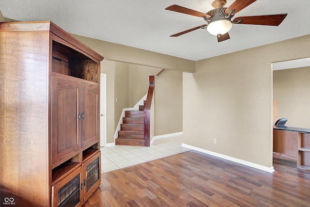 entrance foyer featuring a textured ceiling, light hardwood / wood-style floors, and ceiling fan