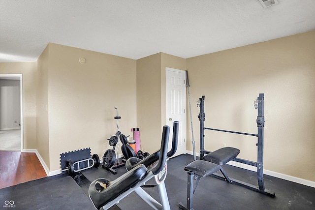 workout room featuring a textured ceiling