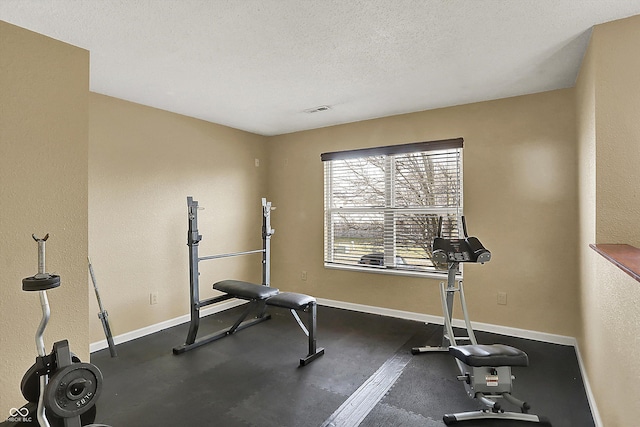 exercise room featuring a textured ceiling