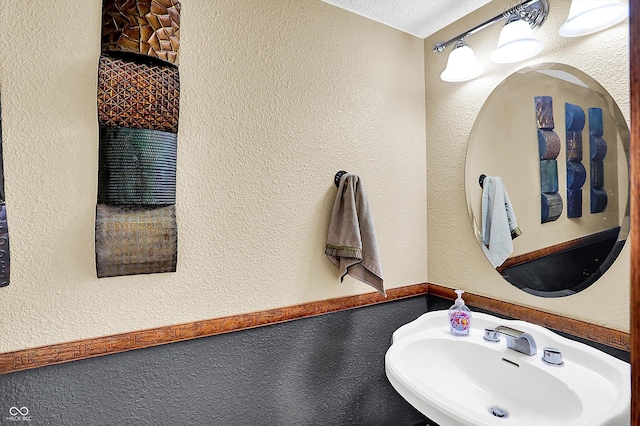 bathroom with sink and a textured ceiling