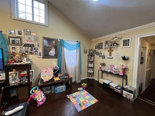 game room with vaulted ceiling, hardwood / wood-style floors, and a textured ceiling