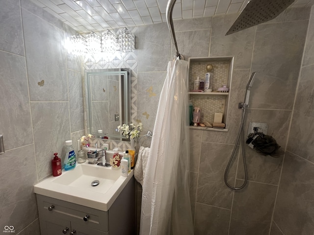 bathroom with a shower with curtain, vanity, and tile walls