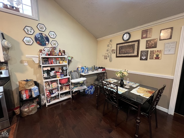 dining space with lofted ceiling, hardwood / wood-style floors, and a textured ceiling