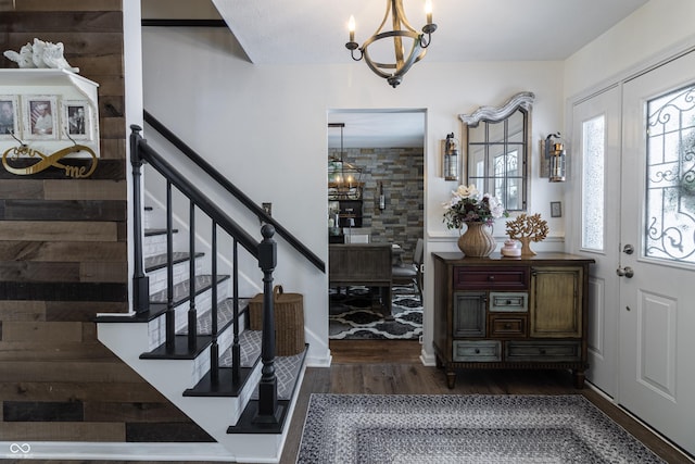 foyer featuring dark wood-style floors, stairway, a chandelier, and french doors