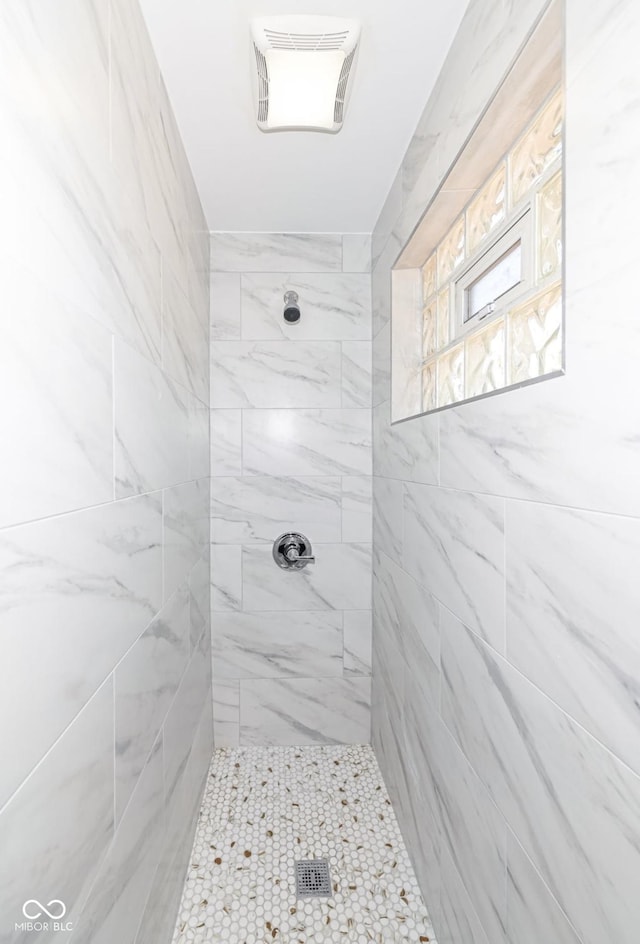 full bathroom with a tile shower