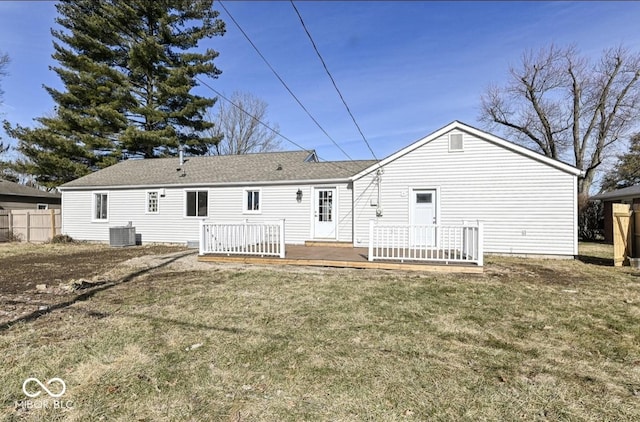 back of property featuring cooling unit, a lawn, a deck, and fence