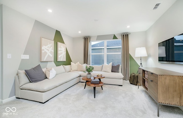 living room featuring recessed lighting, visible vents, baseboards, and light colored carpet