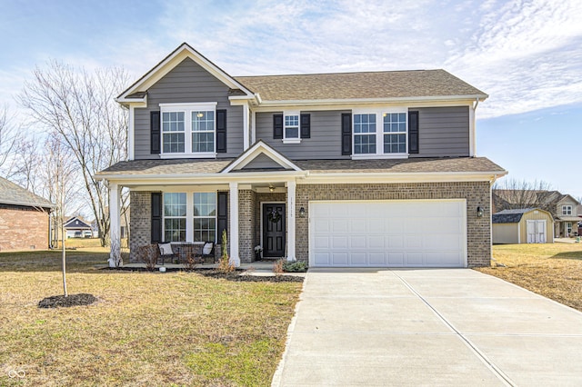 view of front facade featuring a garage, a front yard, and a porch