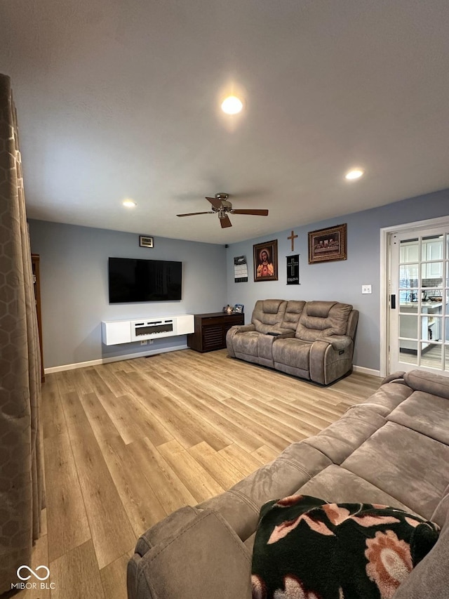 living room featuring ceiling fan and light wood-type flooring