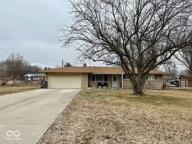 ranch-style house with a garage and a front lawn