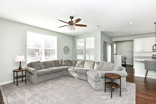 living area with dark wood-style floors, baseboards, a ceiling fan, and recessed lighting